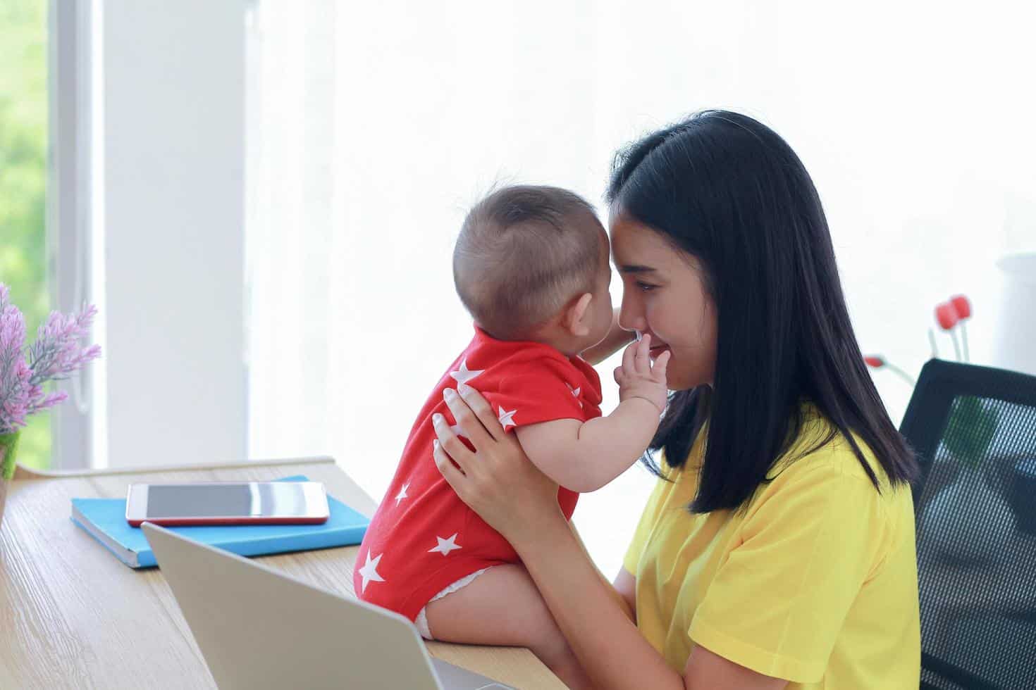 young asian mom working from home free photo